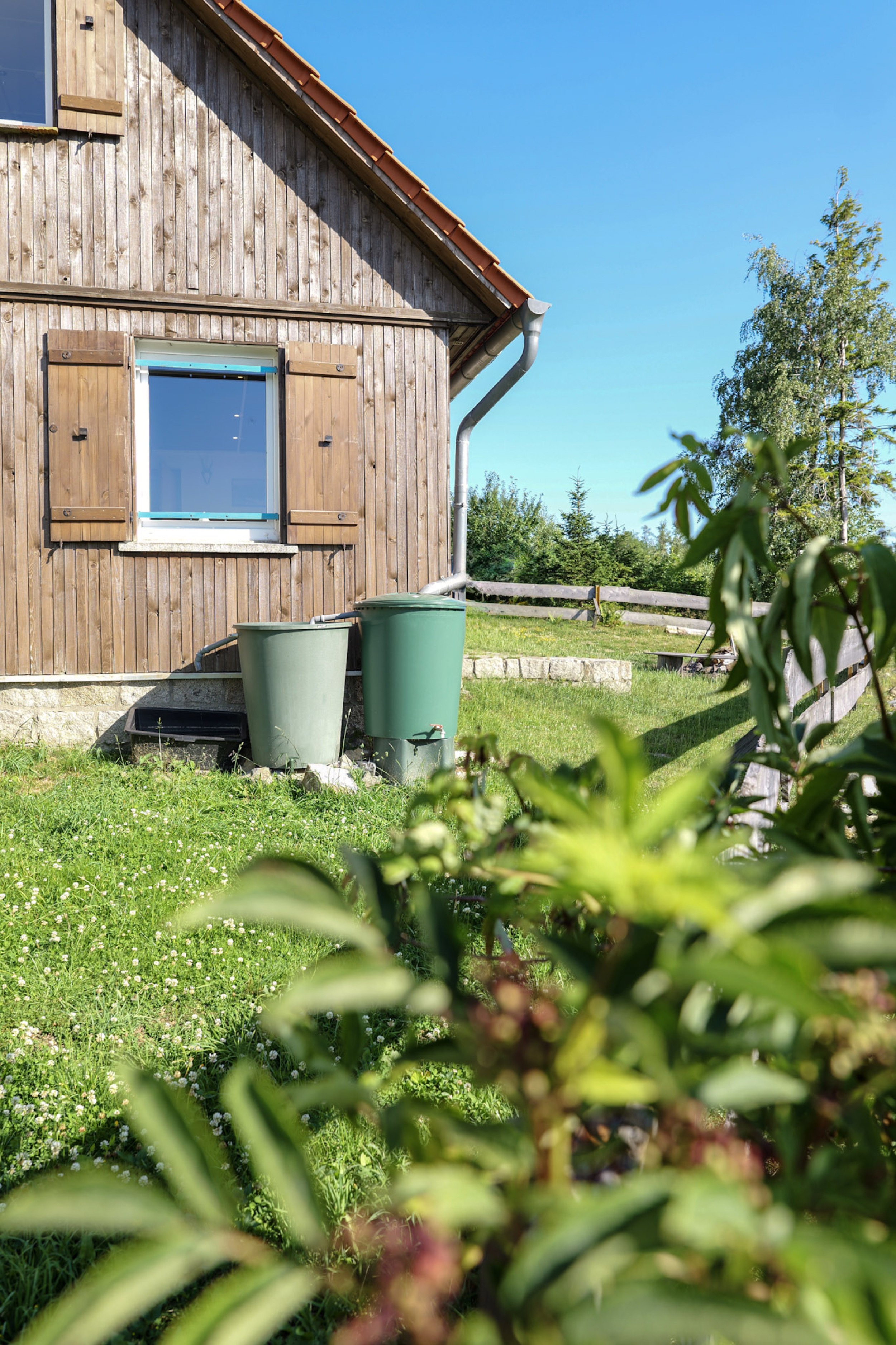 bergwacht-regentonnen-an-hauswand-mit-fensterladen