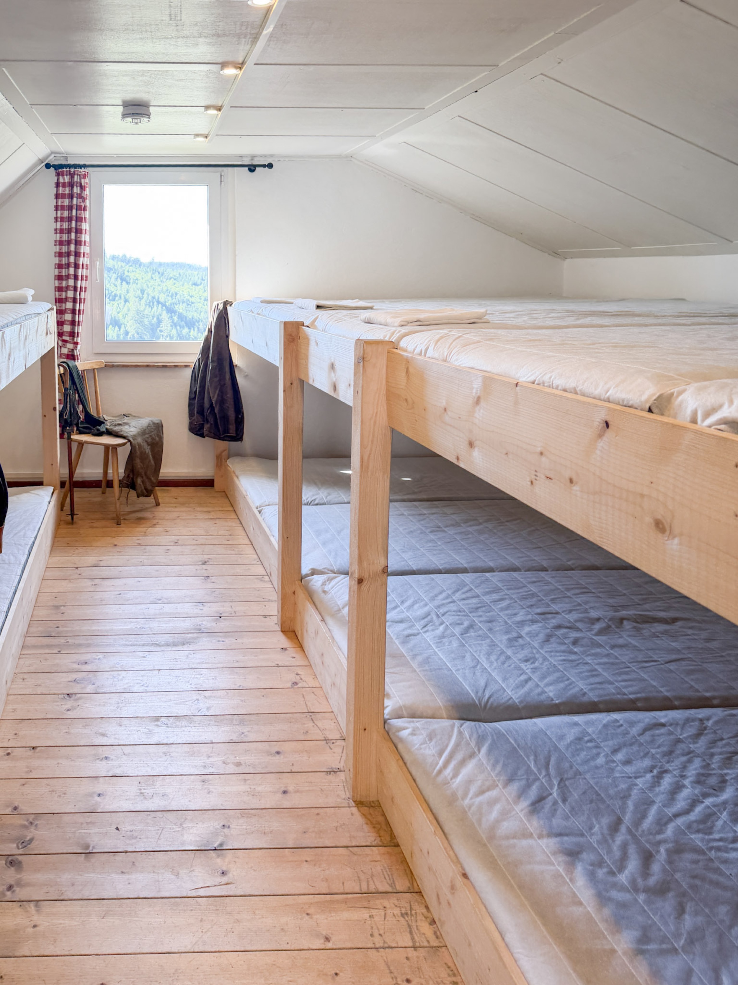 bergwacht-schlafsaal-holzstuhl-mit-jacke-in-ecke