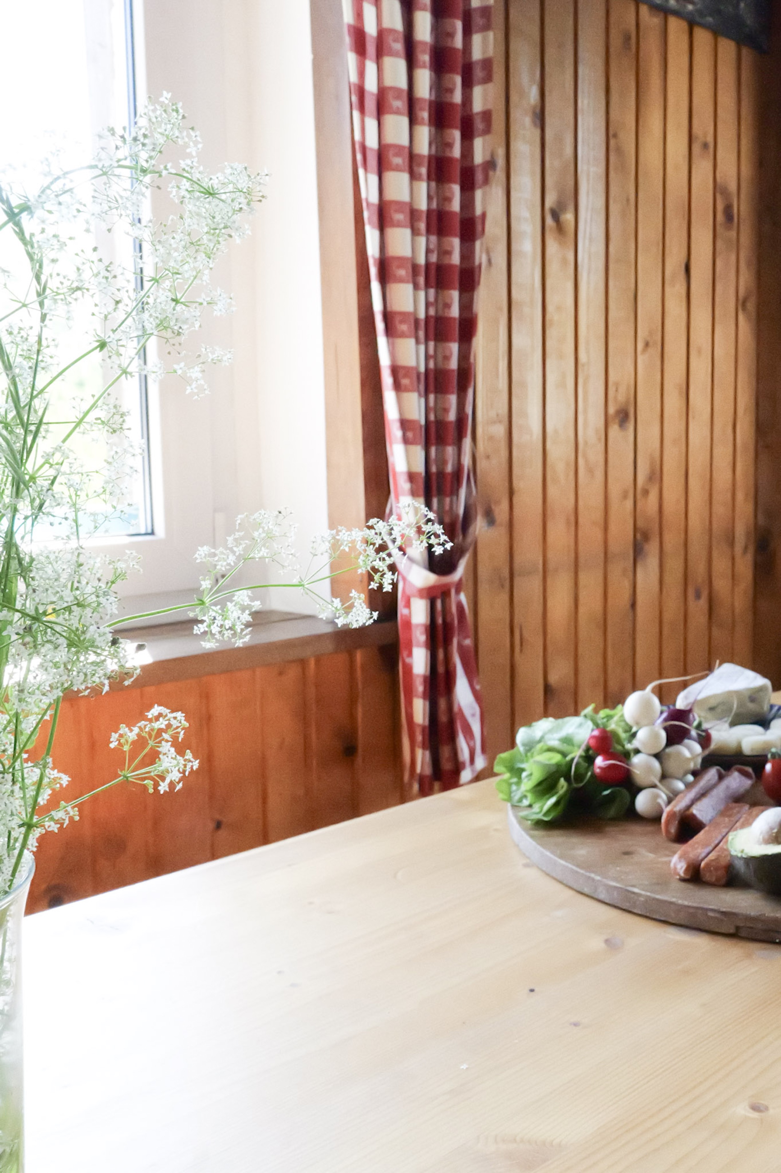 bergwacht-tisch-detail-mit-wiesenblumen-und-kaesebrett