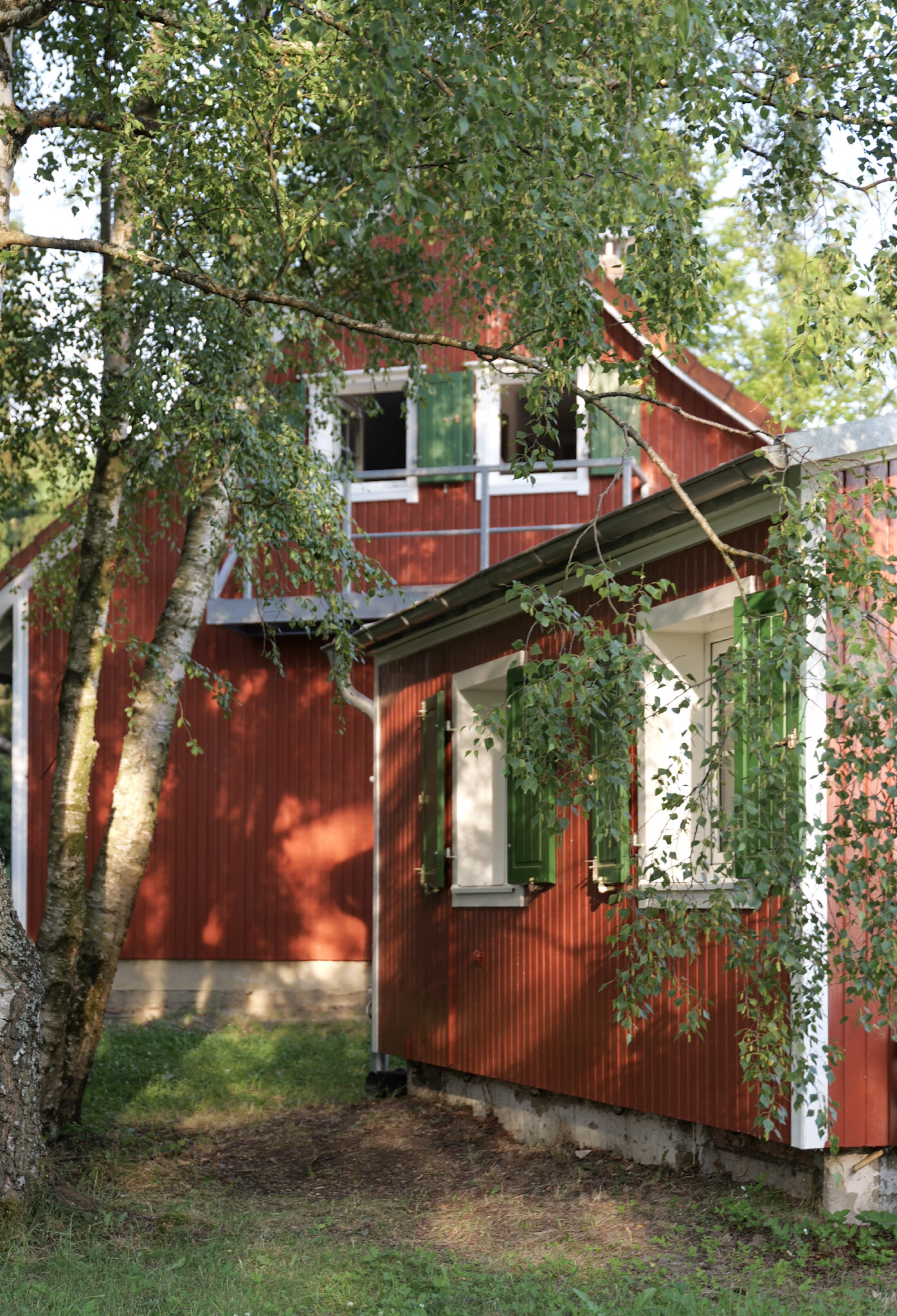 puppenhaus-rotes-haus-mit-balkon-und-offenem-fenster-im-obergeschoss